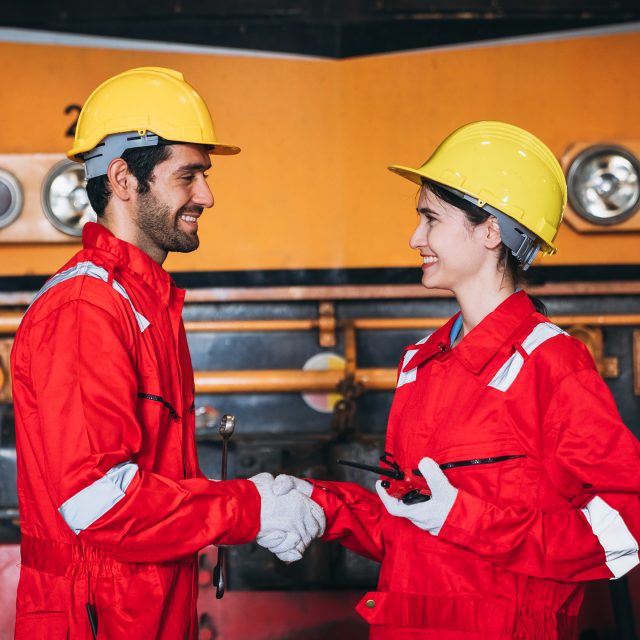 Industrial engineers inspect and perform maintenance on the machines at factory machines. Teamwork in the Manufacturing Industry in the train garage.