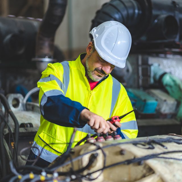 professional technician engineer working to control electrical power and safety service system, electrician working to maintenance and checking industrial equipment in term of factory technology